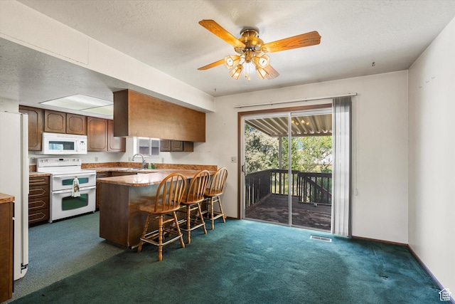 5374 S 5700 W, Hooper, UT 84315 - kitchen with white appliances, a peninsula, dark carpet, a breakfast bar, and a ceiling fan