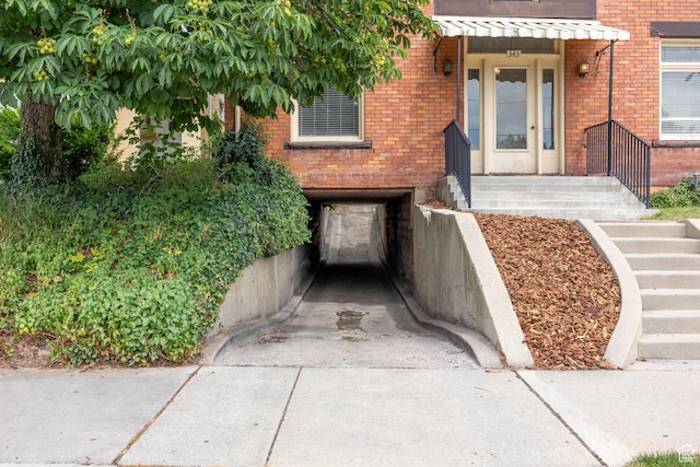 343 S 1300 E, Salt Lake City, UT 84102 - property entrance featuring brick siding, driveway, and a garage
