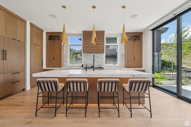 1404 W Ursa Way, Heber City, UT 84032 - kitchen featuring modern cabinets, light wood-style floors, backsplash, and healthy amount of natural light