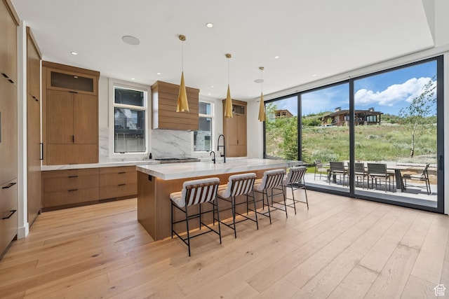 1404 W Ursa Way, Heber City, UT 84032 - kitchen with modern cabinets, brown cabinetry, light countertops, tasteful backsplash, and a wall of windows