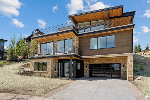 1404 W Ursa Way, Heber City, UT 84032 - contemporary home featuring a balcony, concrete driveway, stone siding, and an attached garage