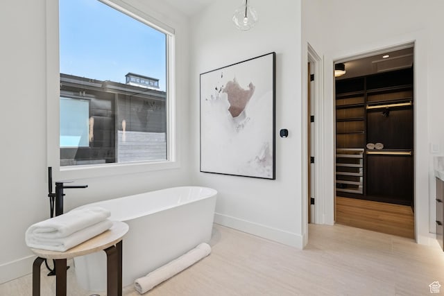 1404 W Ursa Way, Heber City, UT 84032 - bathroom featuring a soaking tub, wood finished floors, and a spacious closet