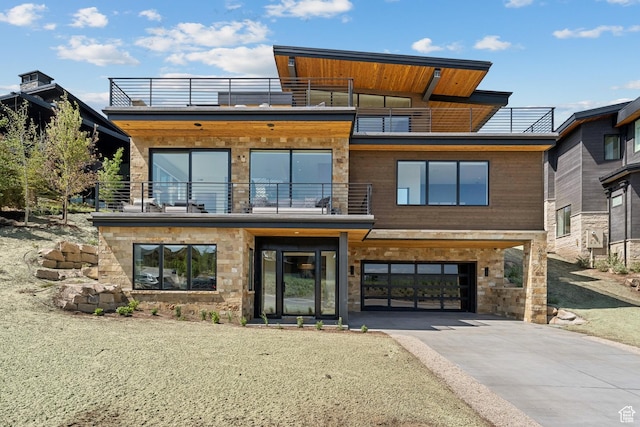 1404 W Ursa Way, Heber City, UT 84032 - contemporary house with a balcony, concrete driveway, a garage, and stone siding