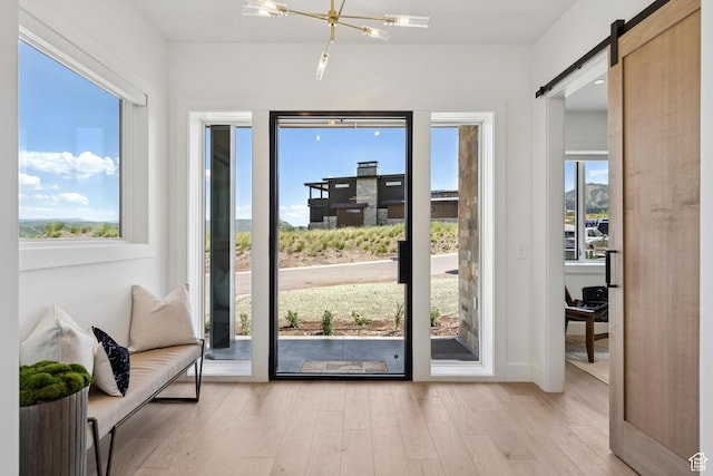 1404 W Ursa Way, Heber City, UT 84032 - entryway featuring a barn door, light wood-type flooring, and a chandelier