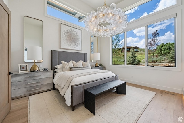 1404 W Ursa Way, Heber City, UT 84032 - bedroom with a chandelier and light wood-style floors