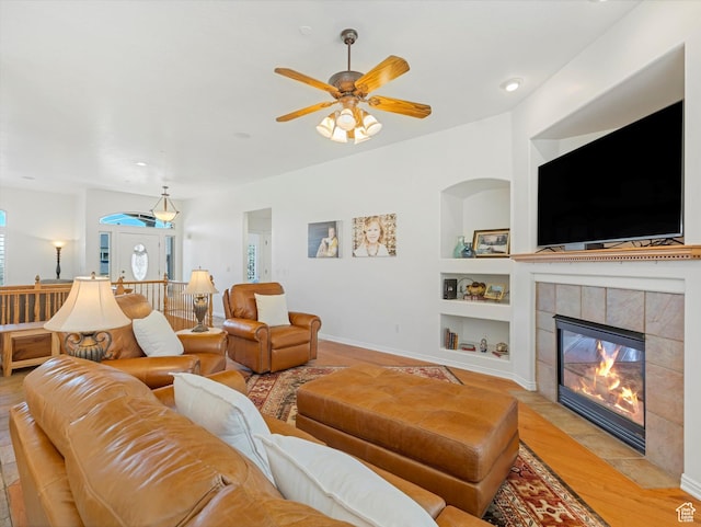 1639 E Lone Oak Dr, Draper, UT 84020 - living area with built in features, light wood-style floors, a ceiling fan, and a fireplace