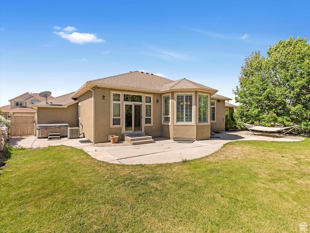 1639 E Lone Oak Dr, Draper, UT 84020 - back of property with a hot tub, a patio area, stucco siding, and a lawn