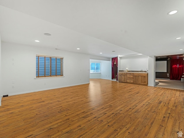 1639 E Lone Oak Dr, Draper, UT 84020 - unfurnished living room with light wood-style flooring, bar with sink, and recessed lighting