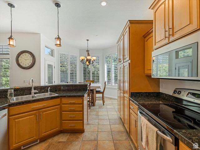 1639 E Lone Oak Dr, Draper, UT 84020 - kitchen featuring stainless steel appliances, a chandelier, hanging light fixtures, dark stone counters, and recessed lighting