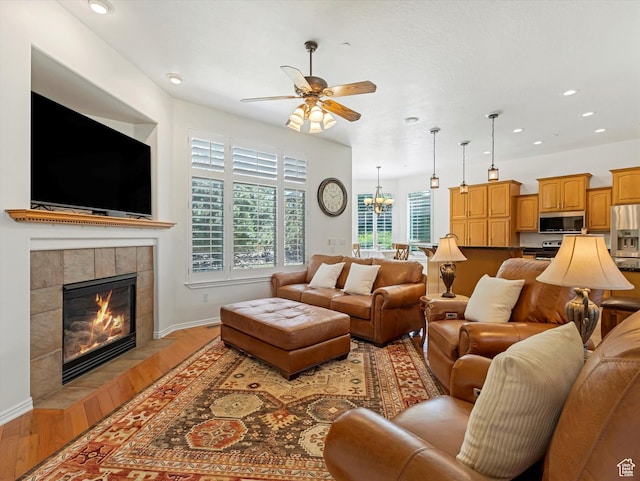 1639 E Lone Oak Dr, Draper, UT 84020 - living area with ceiling fan, a tile fireplace, light wood-style floors, recessed lighting, and a chandelier