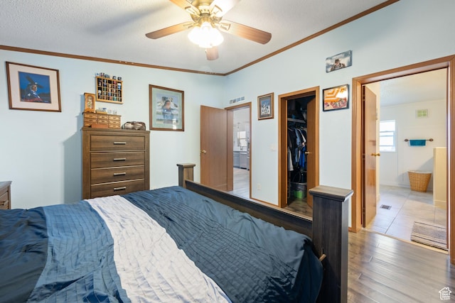 10 E 200 N, La Verkin, UT 84745 - bedroom featuring wood finished floors, a walk in closet, crown molding, ensuite bathroom, and a closet
