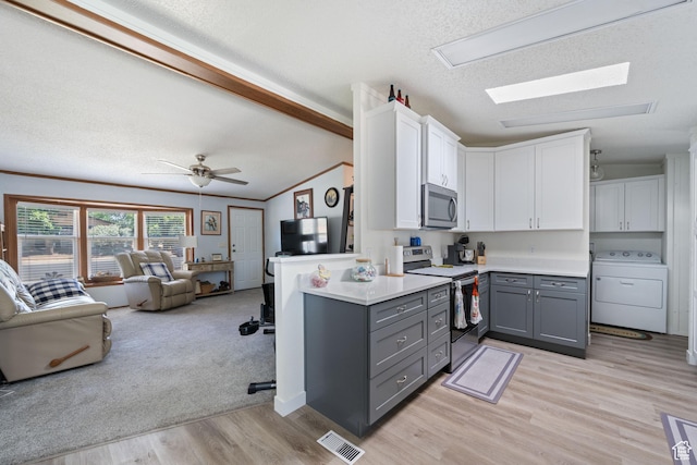 10 E 200 N, La Verkin, UT 84745 - kitchen featuring washer / dryer, gray cabinetry, stainless steel appliances, open floor plan, and white cabinets