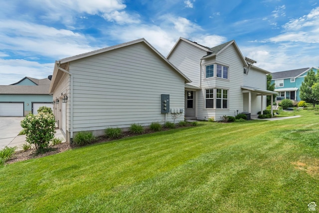 10363 S Silver Mine Rd, South Jordan, UT 84009 - back of house featuring a yard, concrete driveway, and a garage