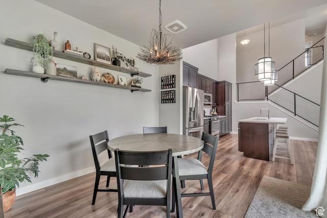 10363 S Silver Mine Rd, South Jordan, UT 84009 - dining space featuring light wood-style floors and a chandelier