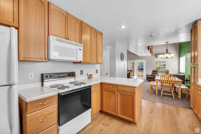 1624 Pine Cone Cir, Coalville, UT 84017 - kitchen with white appliances, a peninsula, light wood finished floors, light countertops, and recessed lighting