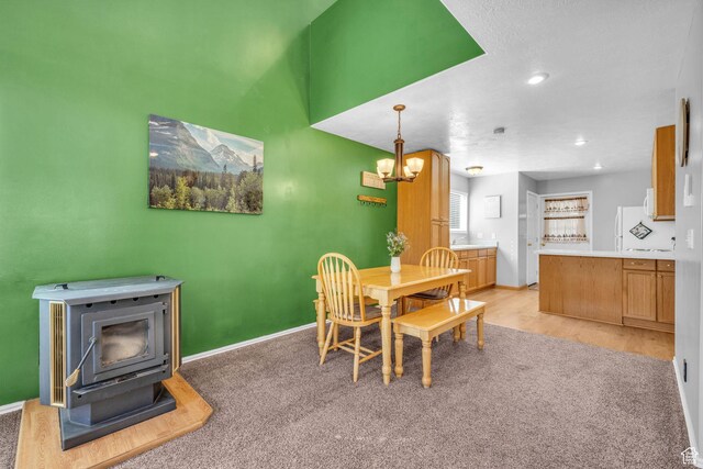 1624 Pine Cone Cir, Coalville, UT 84017 - dining room with a wood stove, a chandelier, recessed lighting, light wood-type flooring, and light carpet