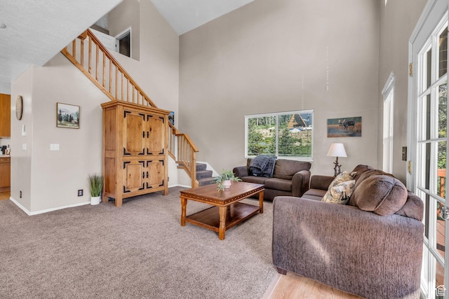 1624 Pine Cone Cir, Coalville, UT 84017 - living room featuring stairs, a towering ceiling, healthy amount of natural light, and light carpet