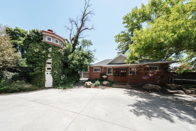 1734 E Spring Ln, Holladay, UT 84117 - view of front facade with french doors, brick siding, and driveway