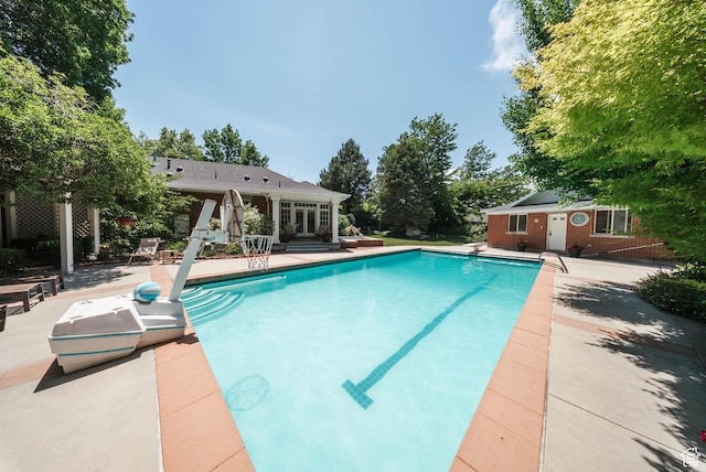 1734 E Spring Ln, Holladay, UT 84117 - swimming pool with a patio area, a diving board, and an outdoor structure