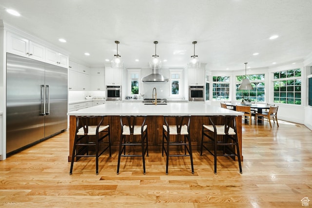 1734 E Spring Ln, Holladay, UT 84117 - kitchen featuring built in fridge, light wood-style flooring, recessed lighting, light countertops, and white cabinets