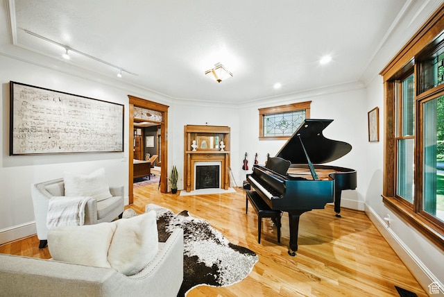 1734 E Spring Ln, Holladay, UT 84117 - living room featuring track lighting, wood finished floors, a fireplace with flush hearth, and crown molding