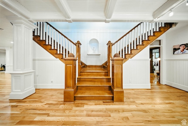 1734 E Spring Ln, Holladay, UT 84117 - stairs featuring decorative columns, wood finished floors, beamed ceiling, a decorative wall, and wainscoting