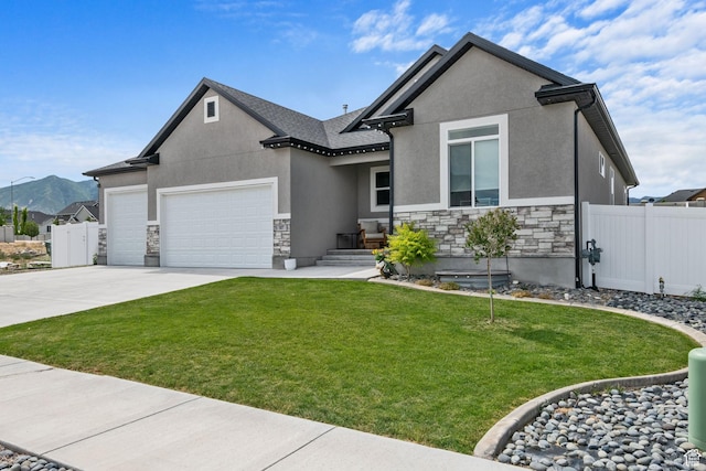 507 W 2030 N, Tooele, UT 84074 - view of front facade with stone siding, an attached garage, and stucco siding