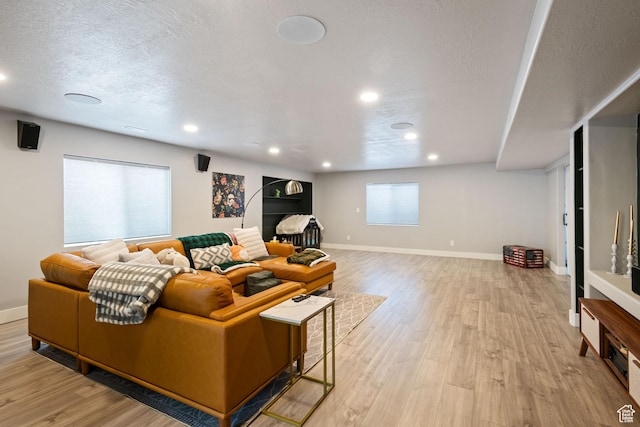 507 W 2030 N, Tooele, UT 84074 - living room featuring light wood-type flooring, a textured ceiling, and recessed lighting