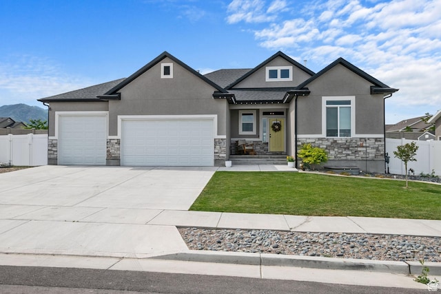 507 W 2030 N, Tooele, UT 84074 - view of front of home with stucco siding, stone siding, an attached garage, concrete driveway, and roof with shingles