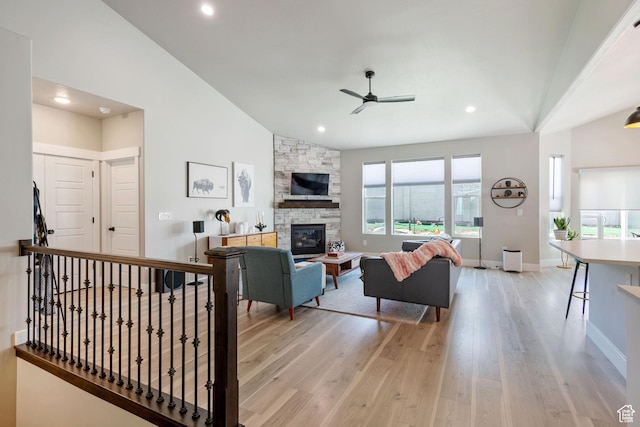 507 W 2030 N, Tooele, UT 84074 - living area featuring ceiling fan, lofted ceiling, light wood-type flooring, a stone fireplace, and recessed lighting