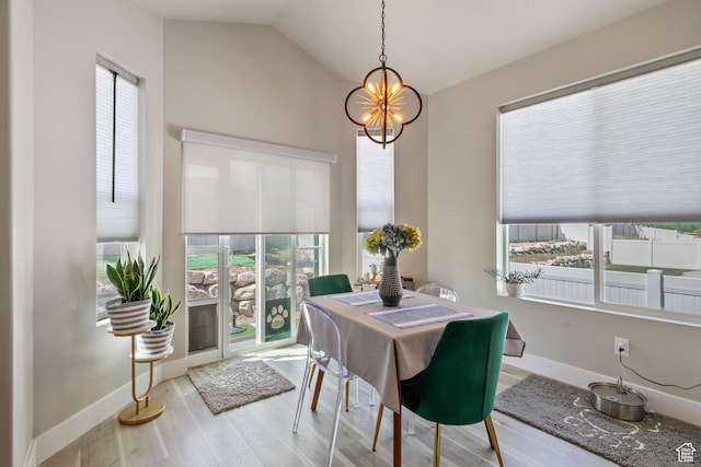 507 W 2030 N, Tooele, UT 84074 - dining space featuring a chandelier, wood finished floors, and vaulted ceiling