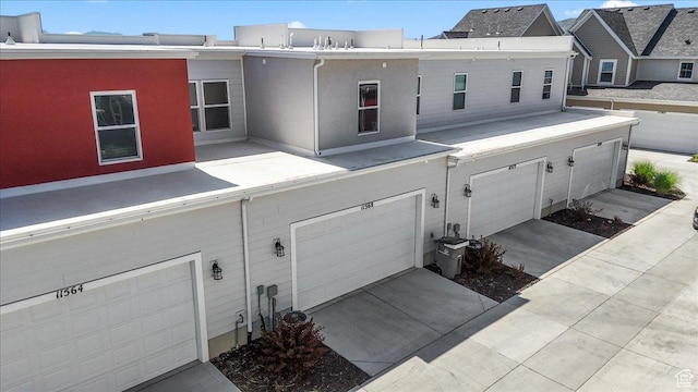 11568 S Watercourse Rd, South Jordan, UT 84009 - back of property with an attached garage, stucco siding, and driveway