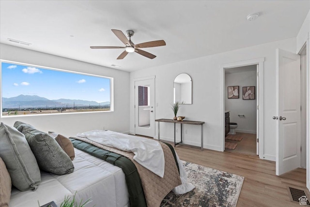 11568 S Watercourse Rd, South Jordan, UT 84009 - bedroom with a mountain view, light wood-type flooring, a ceiling fan, and ensuite bath