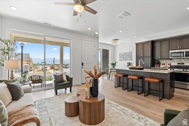 11568 S Watercourse Rd, South Jordan, UT 84009 - living area featuring ceiling fan, light wood-style flooring, a mountain view, and recessed lighting