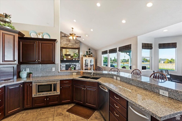 4987 S 5400 W, Hooper, UT 84315 - kitchen with appliances with stainless steel finishes, recessed lighting, a ceiling fan, light stone counters, and a stone fireplace