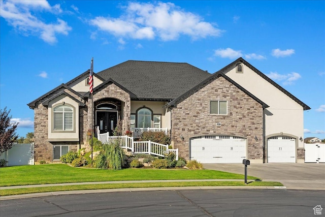 4987 S 5400 W, Hooper, UT 84315 - french country home featuring stone siding, a garage, stucco siding, driveway, and a porch
