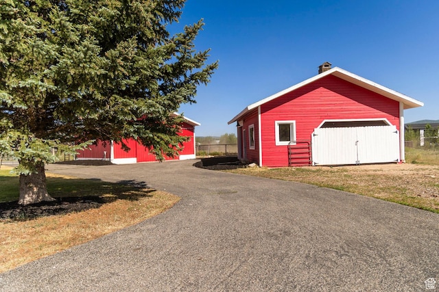 266 Old Ranch Rd W, Park City, UT 84098 - exterior space with an outbuilding, a detached garage, and a chimney