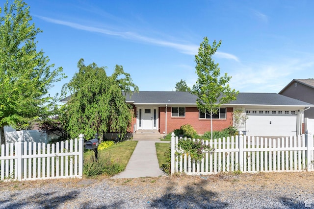 780 Loader Dr, Pleasant Grove, UT 84062 - view of front of home featuring a garage, a fenced front yard, brick siding, and concrete driveway