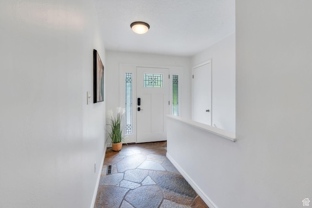 780 Loader Dr, Pleasant Grove, UT 84062 - doorway to outside featuring baseboards and stone finish flooring