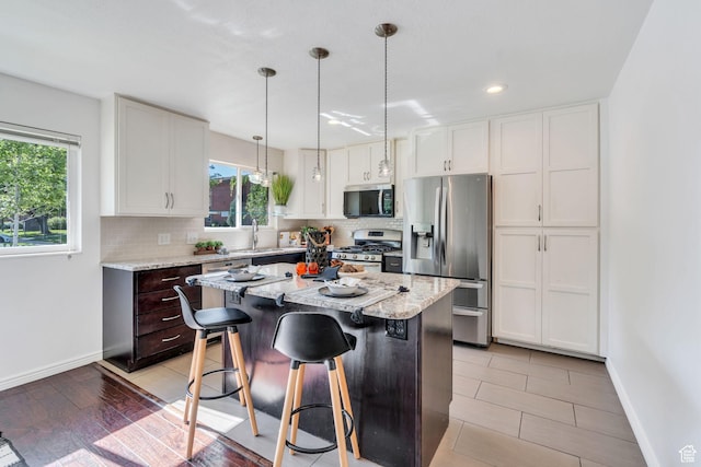 780 Loader Dr, Pleasant Grove, UT 84062 - kitchen featuring appliances with stainless steel finishes, plenty of natural light, tasteful backsplash, a breakfast bar, and recessed lighting