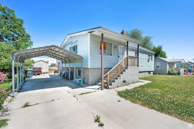 1579 S 1000 W, Salt Lake City, UT 84104 - view of front of home with a detached carport, driveway, a front lawn, and a chimney