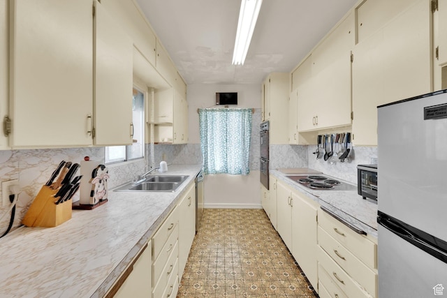 1579 S 1000 W, Salt Lake City, UT 84104 - kitchen with stainless steel appliances, light countertops, light floors, cream cabinetry, and backsplash