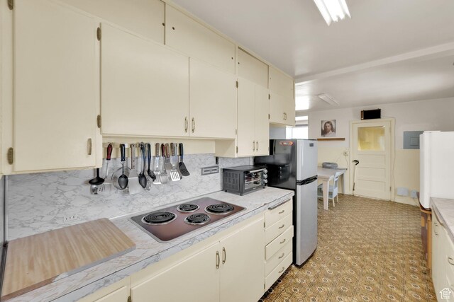 1579 S 1000 W, Salt Lake City, UT 84104 - kitchen featuring freestanding refrigerator, stainless steel stovetop, light countertops, tasteful backsplash, and electric panel