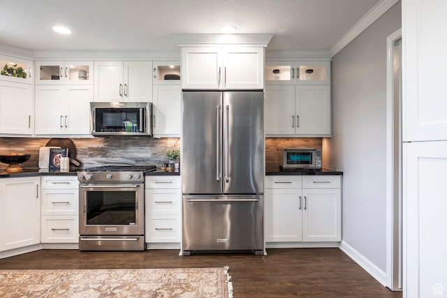 983 Mountain Willow Ln, Park City, UT 84098 - kitchen featuring appliances with stainless steel finishes, dark countertops, dark wood finished floors, decorative backsplash, and white cabinetry