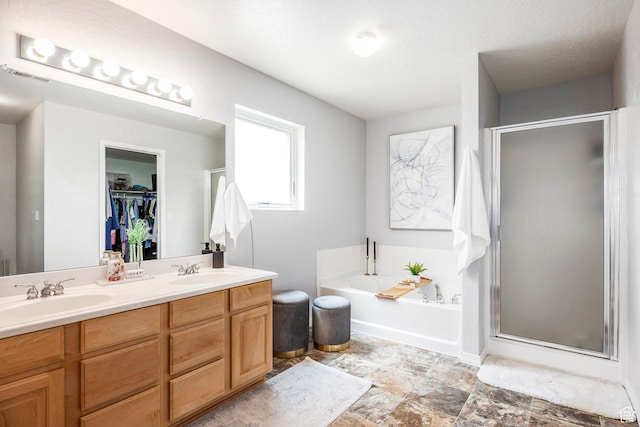 983 Mountain Willow Ln, Park City, UT 84098 - bathroom featuring a shower stall, a bath, double vanity, and a spacious closet
