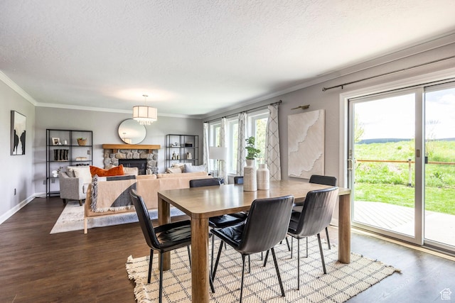 983 Mountain Willow Ln, Park City, UT 84098 - dining room featuring a textured ceiling, a stone fireplace, ornamental molding, and wood finished floors