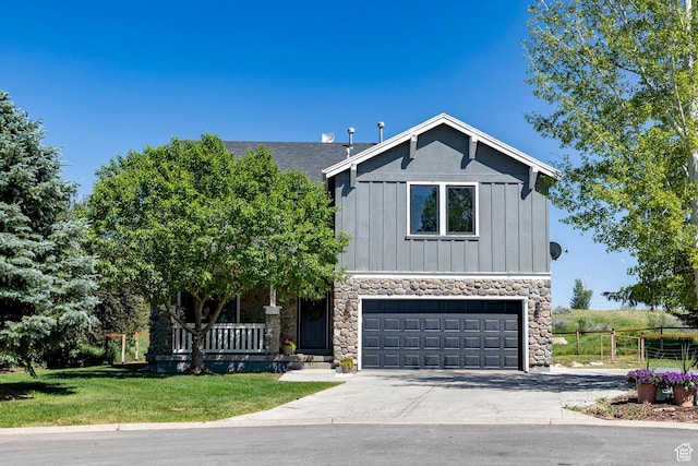 983 Mountain Willow Ln, Park City, UT 84098 - view of front of property with stone siding, concrete driveway, board and batten siding, a garage, and a porch