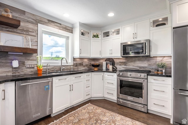 983 Mountain Willow Ln, Park City, UT 84098 - kitchen featuring stainless steel appliances, dark countertops, dark wood-style floors, white cabinetry, and backsplash