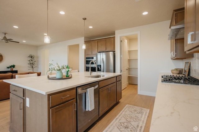 46 Rosalia Rdg, St George, UT 84770 - kitchen featuring stainless steel appliances, open floor plan, recessed lighting, decorative light fixtures, and light wood-style flooring