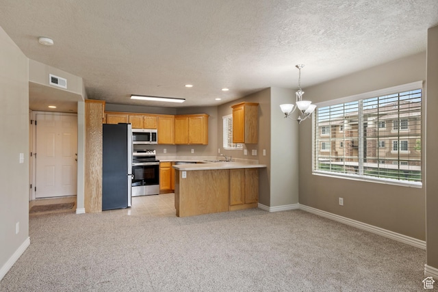 211 E Spencer Peak Way Unit H6, Draper, UT 84020 - kitchen featuring stainless steel appliances, a chandelier, open floor plan, light countertops, and light carpet